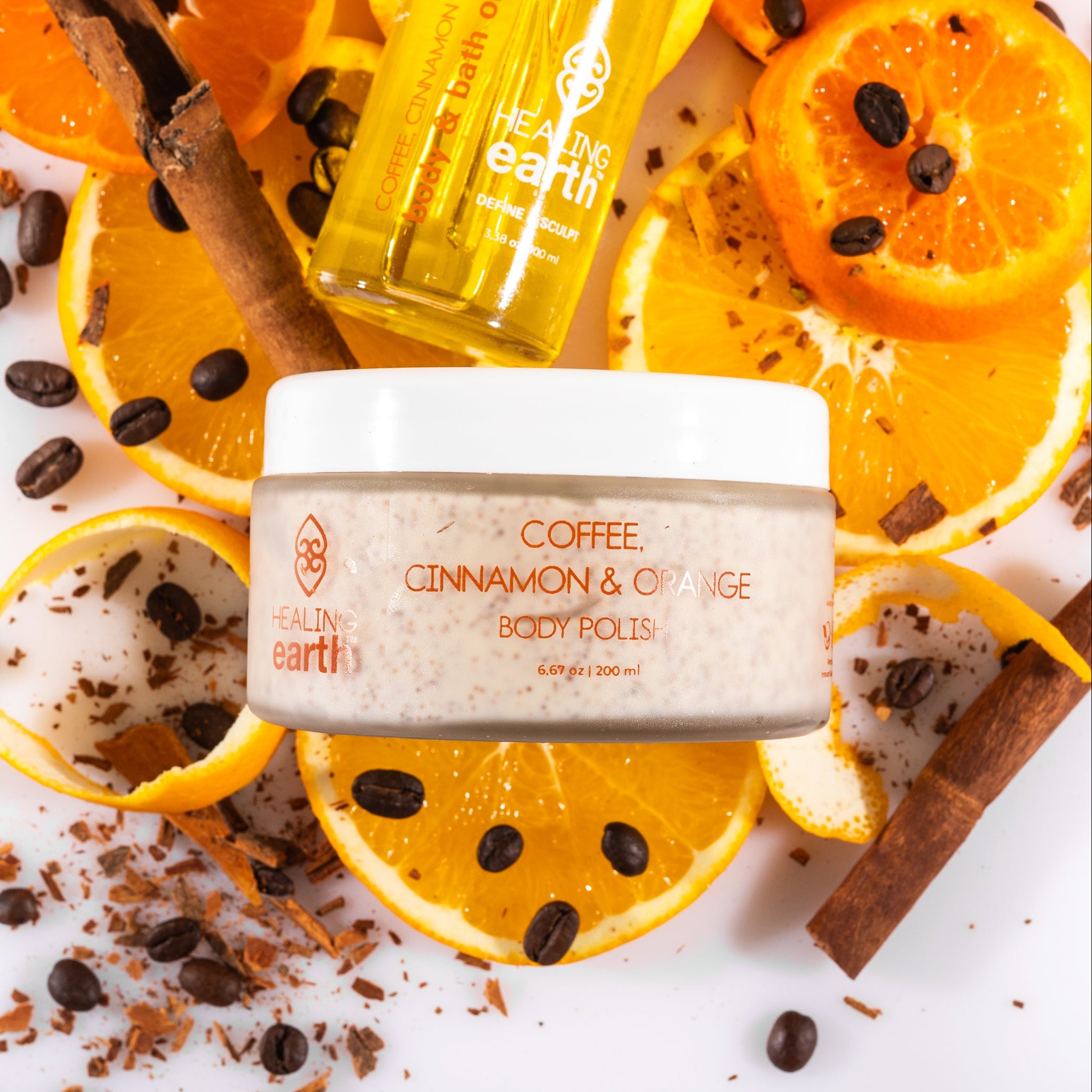 Body polish scrub with coffee, cinnamon, and orange on a white background